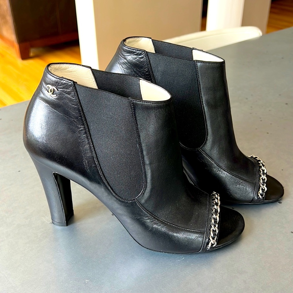 Chanel leather peep-toe ankle booties with silver chain.